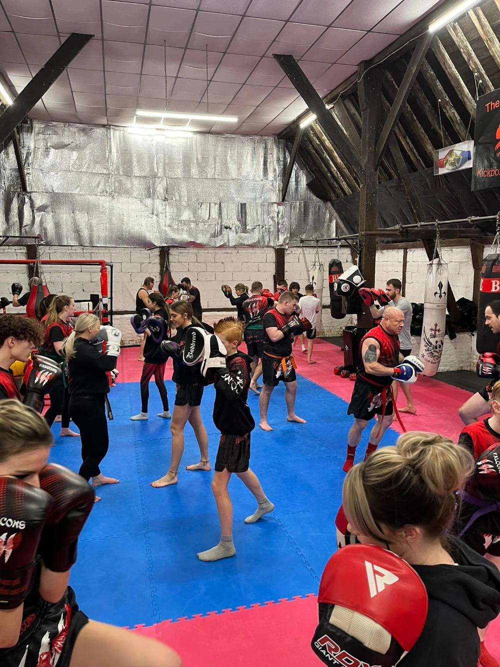 A Falcons Kickboxing class training on the mats at The Old Barn