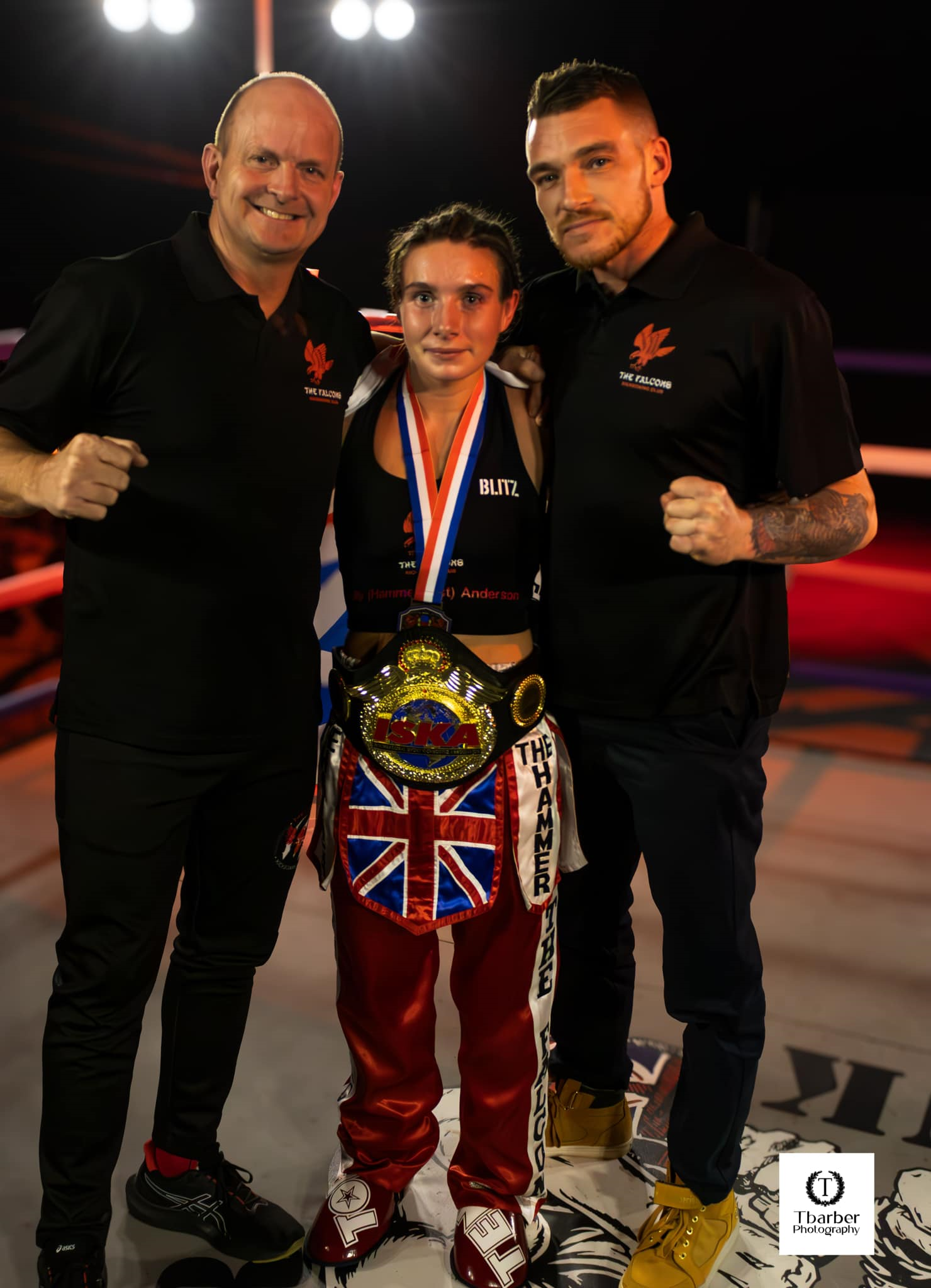 Three Falcons Kickboxing members, one holding a championship belt